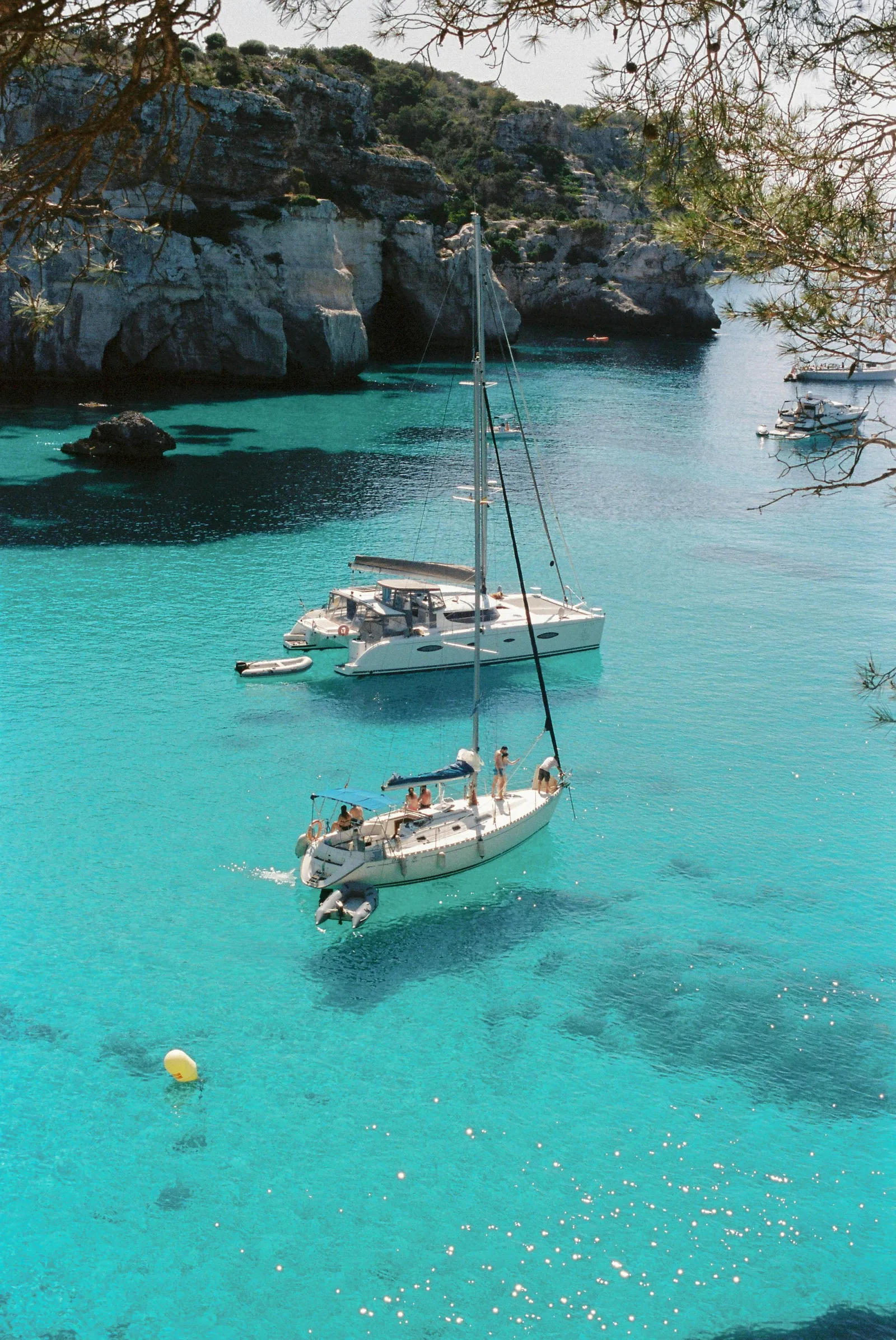 A sailboat in a turquoise Menorca cove — an image of the quiet life.