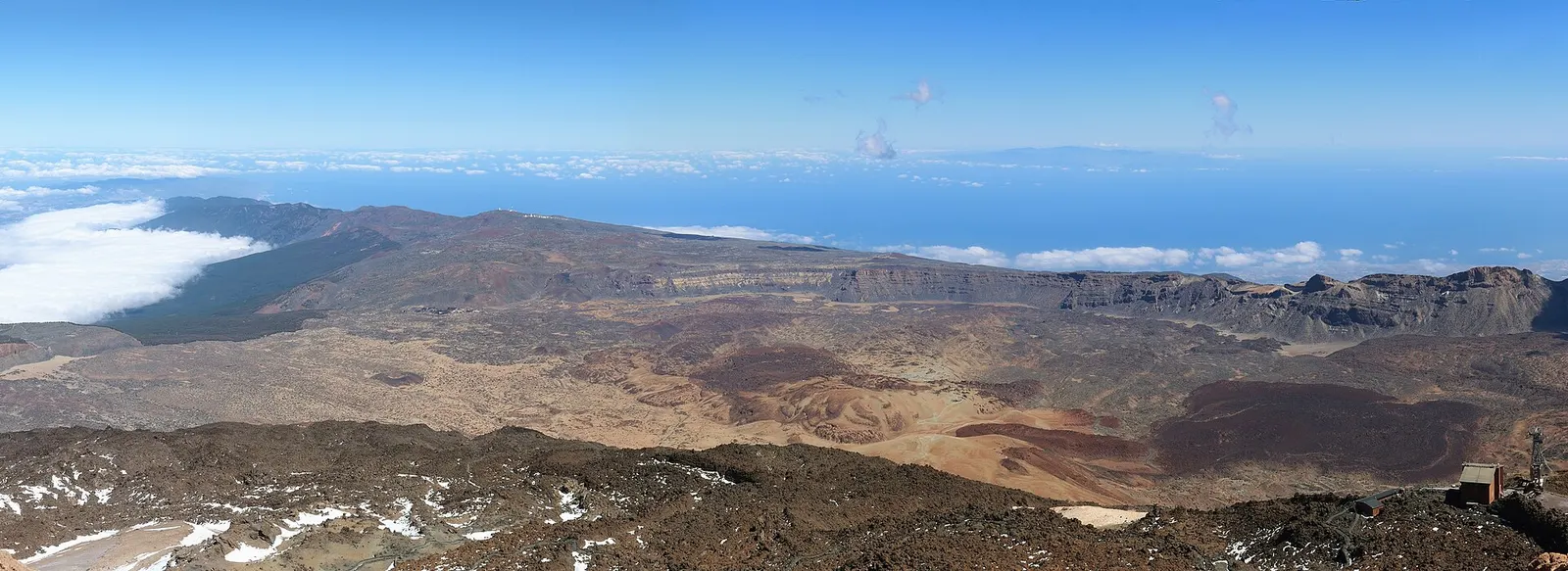 Vista desde la cumbre del Teide sobre la caldera de Las Cañadas, con el mar de nubes y el océano al fondo.